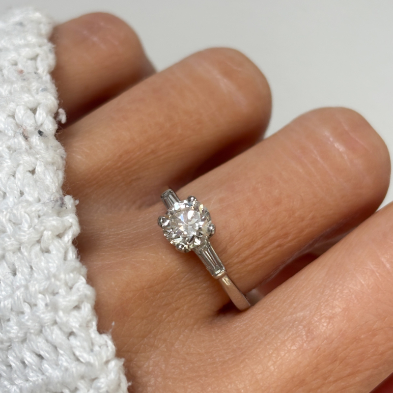 art deco diamond solitaire ring with baguette diamond shoulders 1.04ct for sale in Leeds, UK, shown on lady's finger