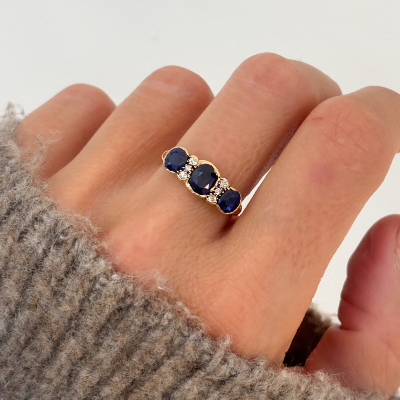 antique Edwardian sapphire and diamond three stone ring in 18ct yellow gold for sale in Leeds, UK, shown on woman's finger