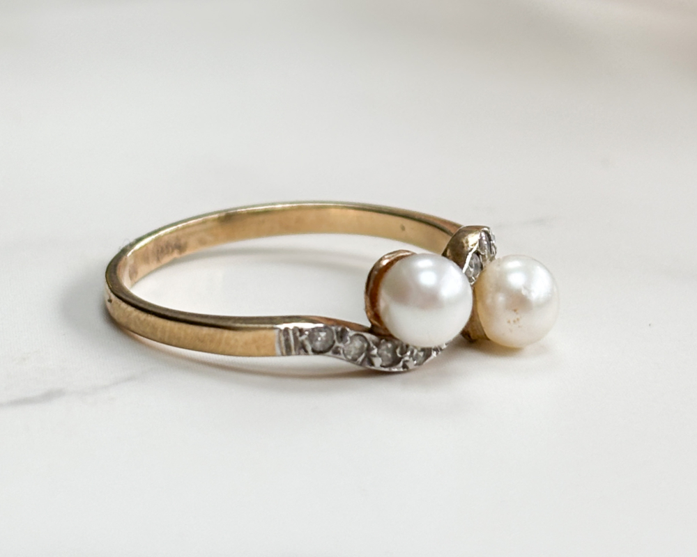antique Edwardian pearl toi et moi ring set with diamonds, showing side view of the ring