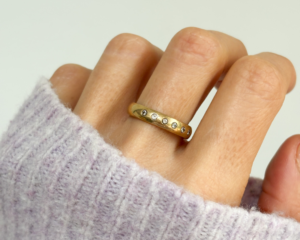 vintage 9ct gold diamond band with flush set diamonds for sale in Leeds, shown worn on lady's finger