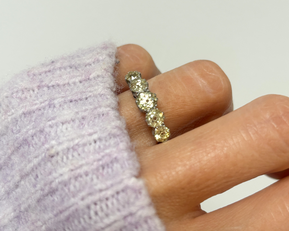 antique yellow diamond five stone ring in platinum for sale in Leeds, UK, pictured on woman's finger