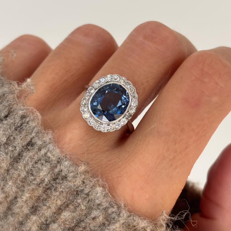 antique Art Deco 1930s blue spinel and diamond cluster ring for sale in Leeds, shown on a woman's finger