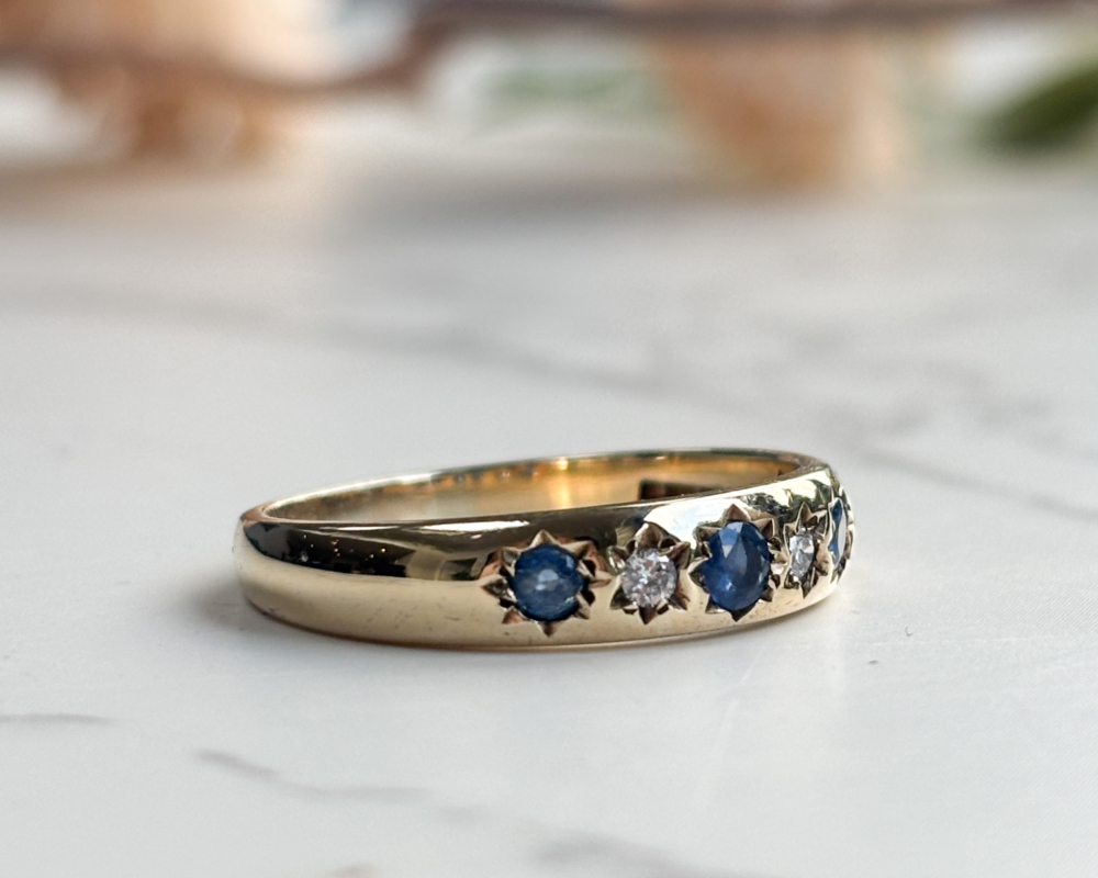 vintage sapphire and diamond ring with star setting in 9ct gold for sale in Leeds, UK, showing side of the ring