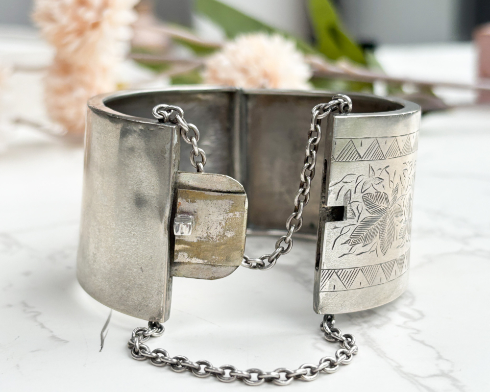 antique Victorian wide silver cuff bangle showing the bangle open and the safety chain