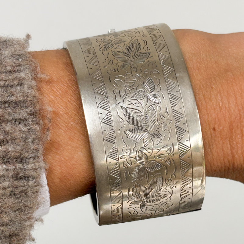 antique Victorian wide silver cuff bangle shown on woman's wrist
