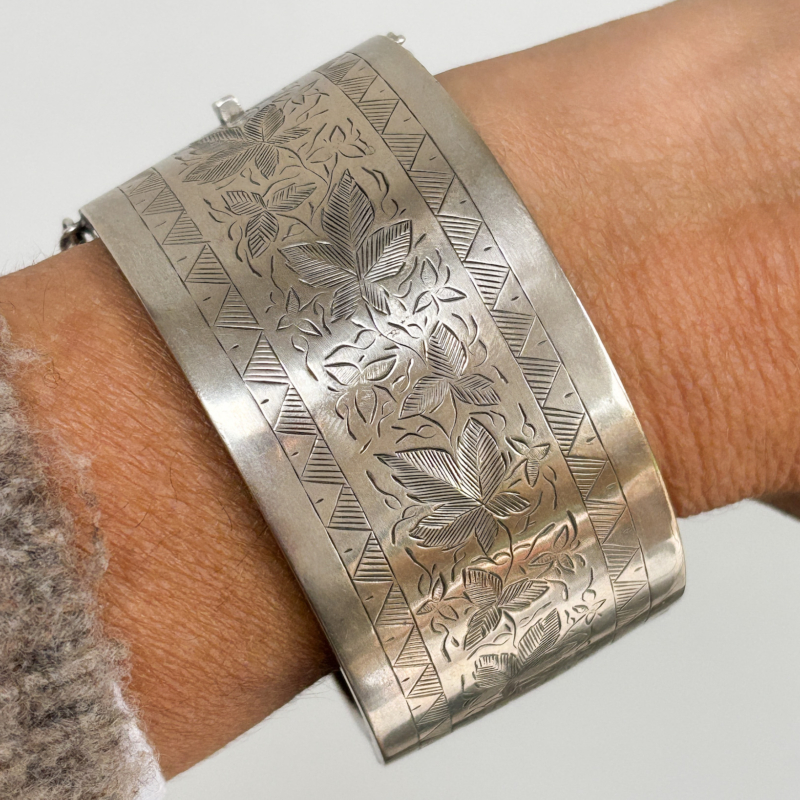 antique Victorian wide silver cuff bangle shown on woman's wrist