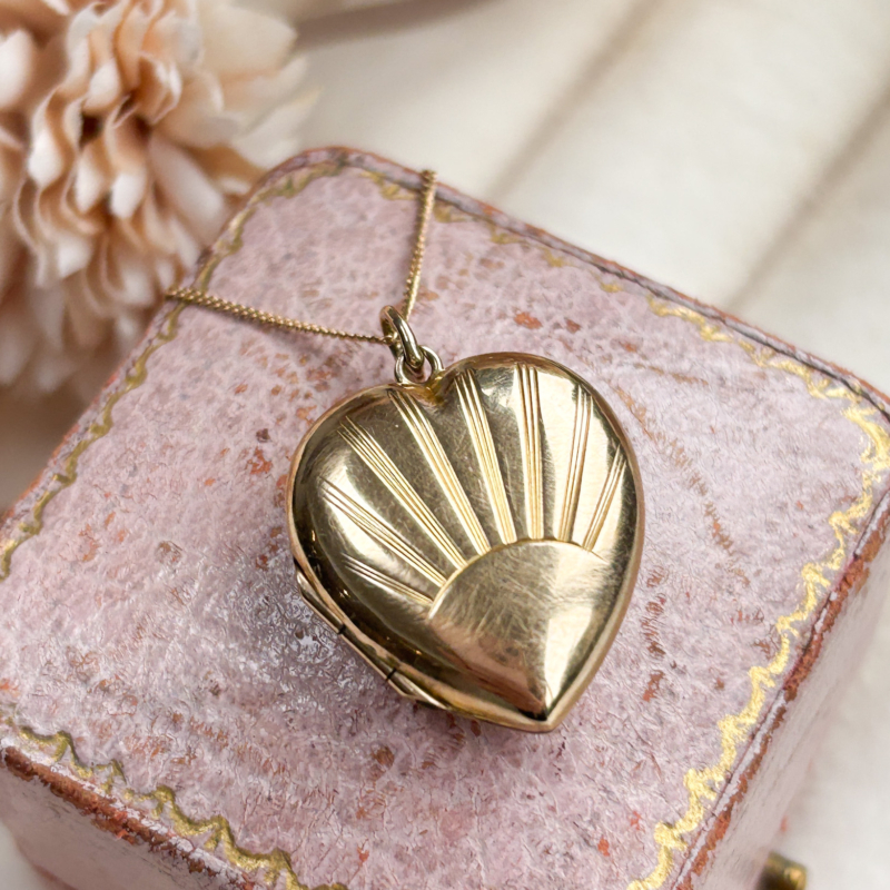 vintage gold sunburst heart locket and chain for sale in Leeds, displayed on a pink box