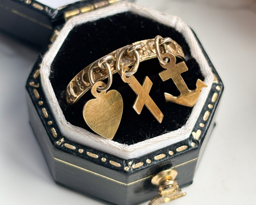 antique Victorian faith, hope and charity ring in 9ct gold for sale in Leeds, UK, shown in a black box