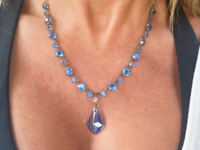 antique 1920s blue glass necklace on woman's neck