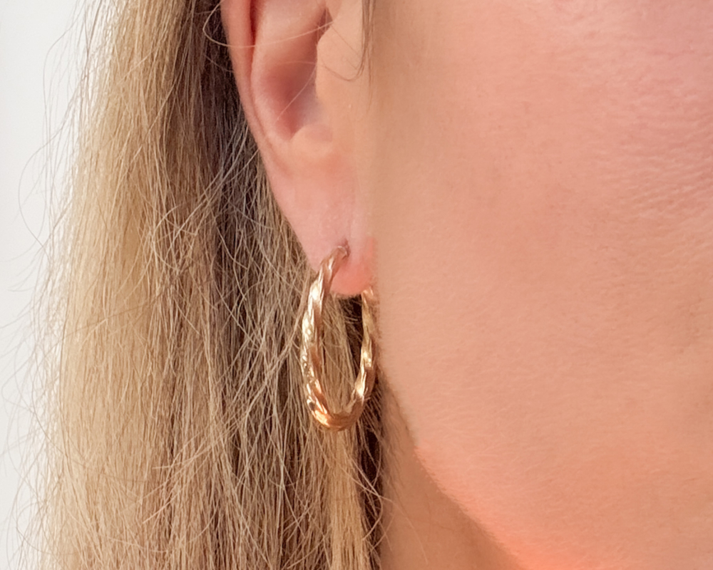 vintage 9ct gold hoops with woven effect design. For sale in Leeds, Yorkshire, shown in woman's ear