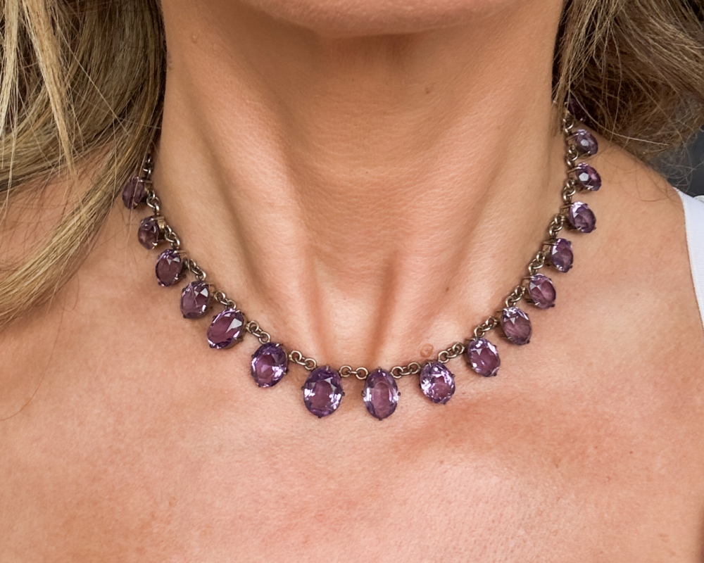 antique Edwardian silver and amethyst riviere necklace in silver. Shown worn on a woman's neck. For sale in Leeds