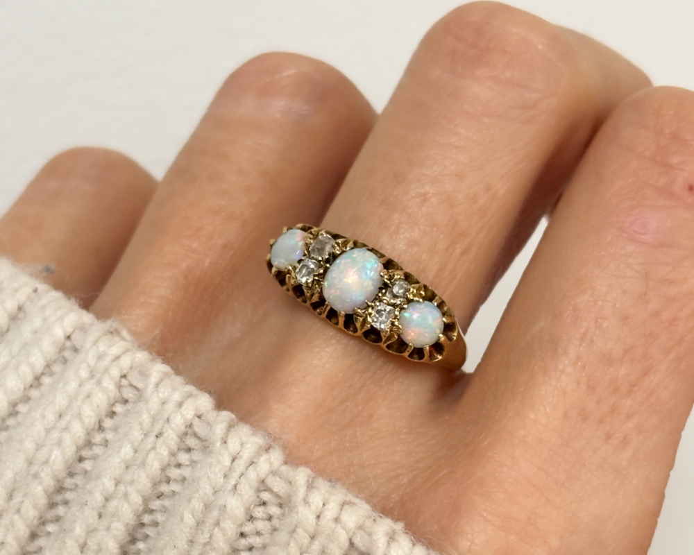 antique Victorian opal and diamond ring in 18ct yellow gold for sale in Leeds, shown on lady's finger