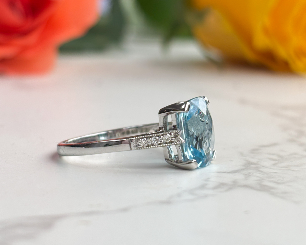art deco style blue topaz and diamond ring in 9ct white gold for sale in Leeds, showing side view of the ring