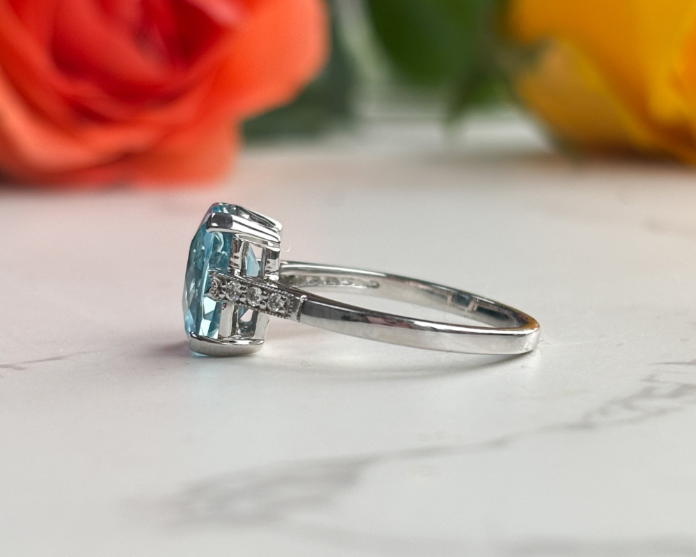 art deco style blue topaz and diamond ring in 9ct white gold for sale in Leeds, showing side view of the ring
