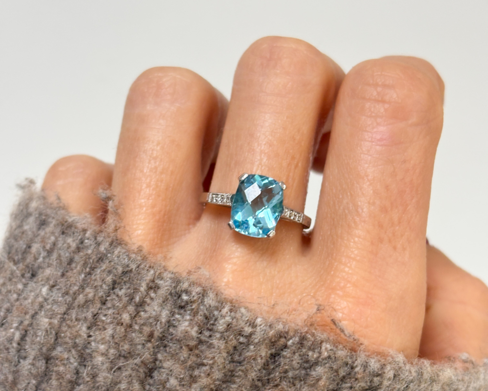 art deco style blue topaz and diamond ring in 9ct white gold for sale in Leeds, shown on lady's finger