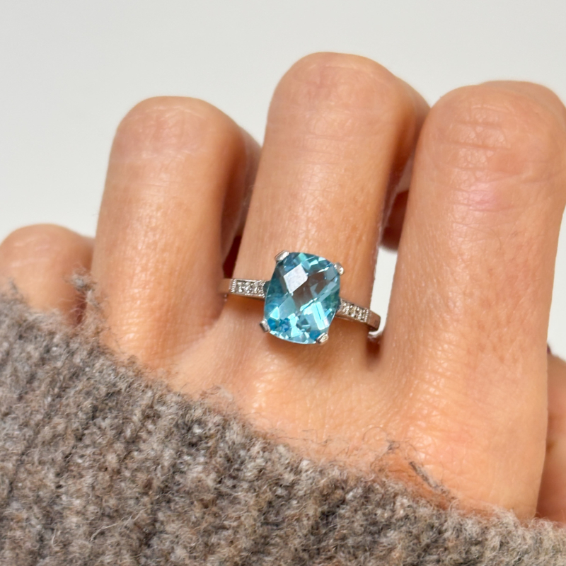 art deco style blue topaz and diamond ring in 9ct white gold for sale in Leeds, shown on lady's finger