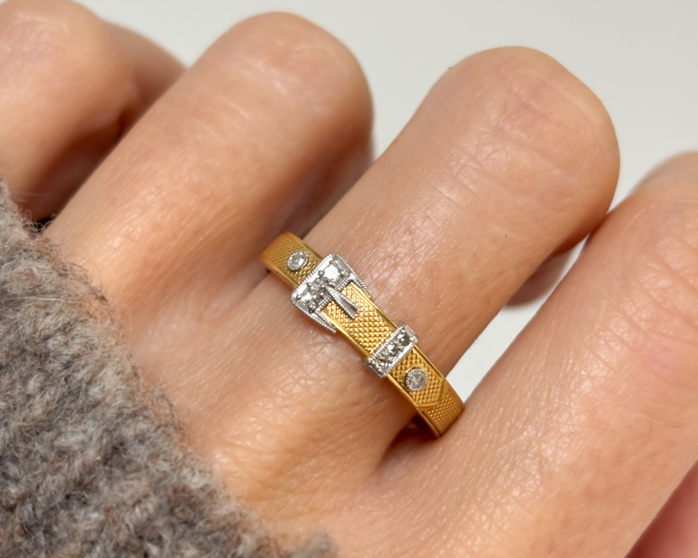 antique diamond buckle ring in 18ct gold and platinum, for sale in Leeds, UK, shown on lady's finger
