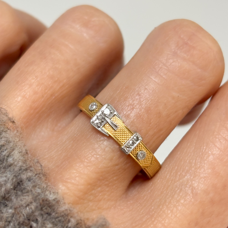 antique diamond buckle ring in 18ct gold and platinum, for sale in Leeds, UK, shown on lady's finger
