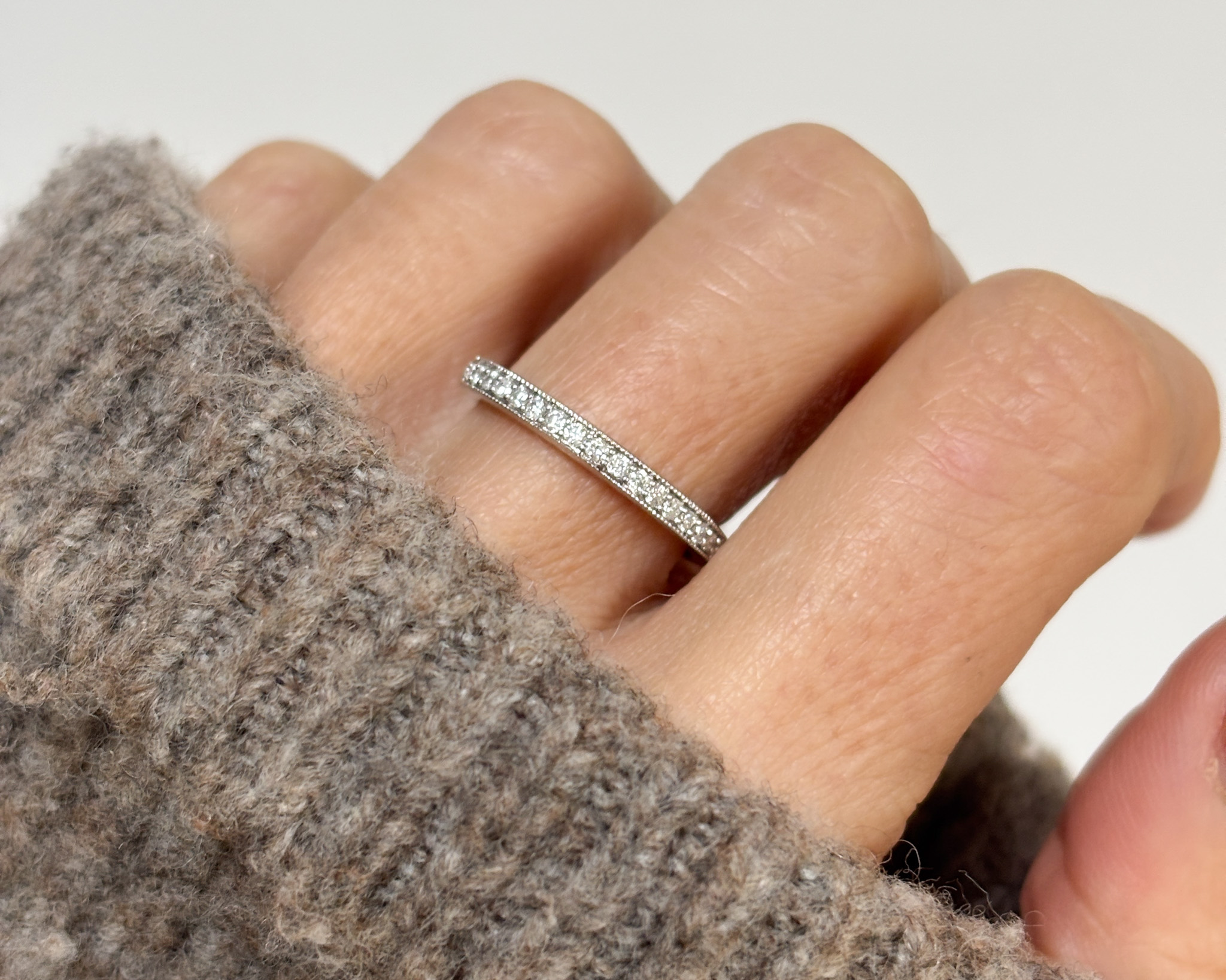 woman wearing white gold half eternity diamond ring