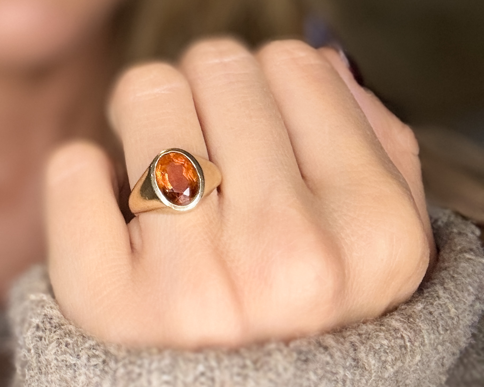 citrine signet ring on woman’s hand