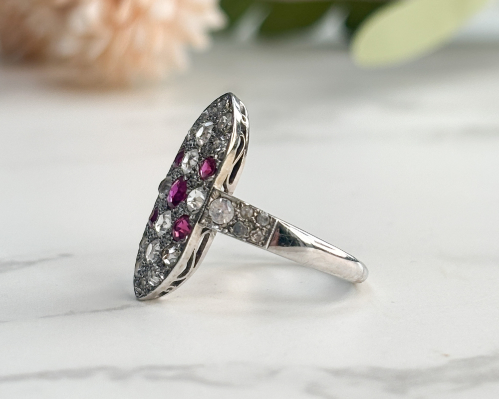Art Deco ruby and diamond plaque ring with white sapphires, old and rose cut diamonds in 9ct white gold for sale in Leeds, showing side view
