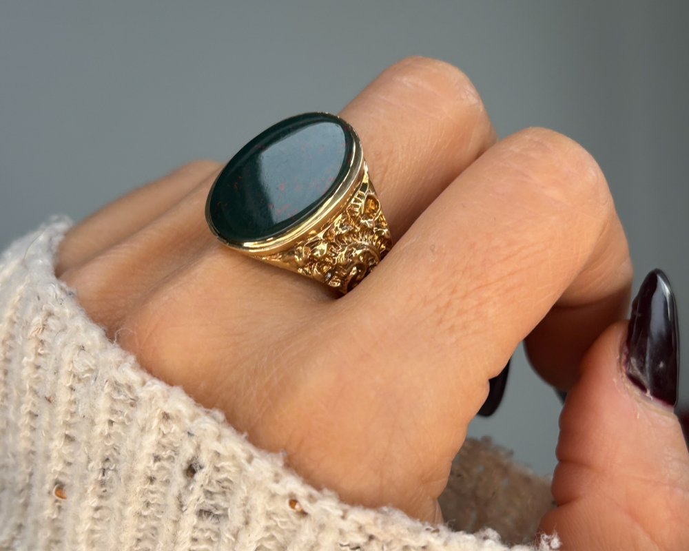vintage bloodstone signet ring in 9ct gold over 9g in weight, shown on woman