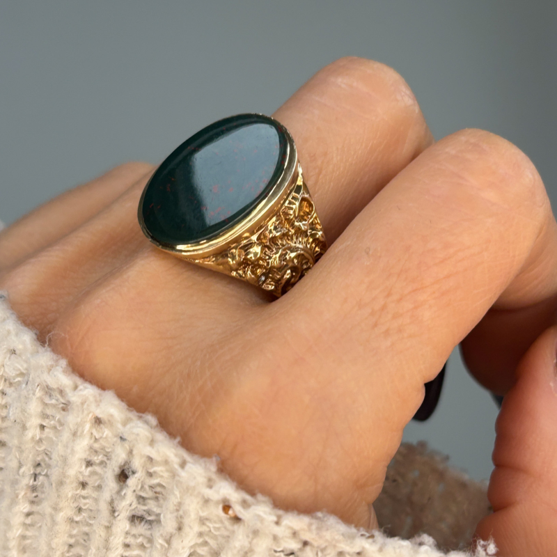vintage bloodstone signet ring in 9ct gold over 9g in weight, shown on woman
