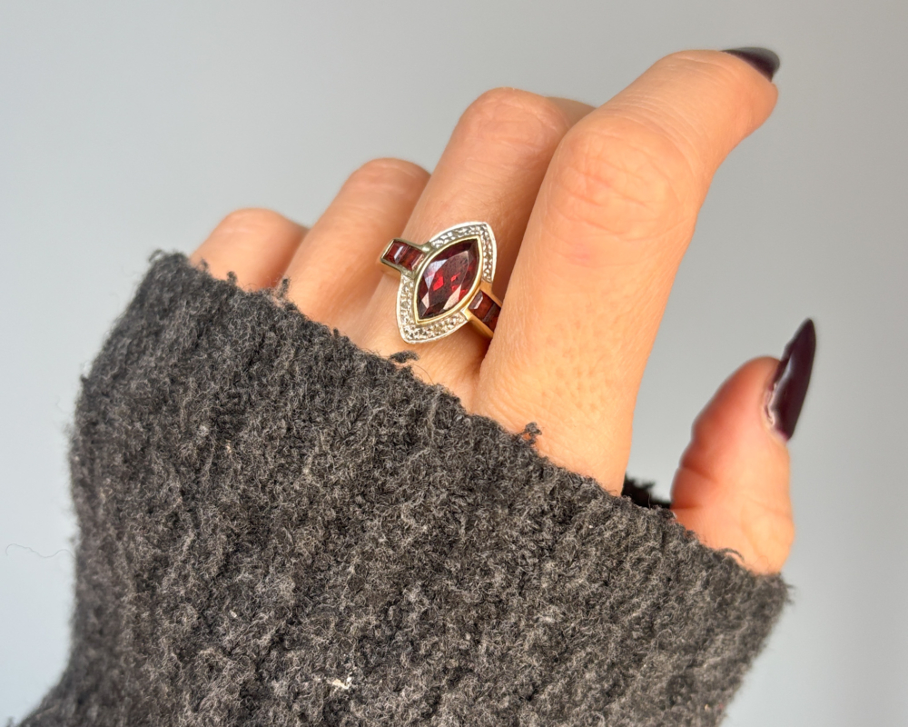 vintage garnet statement ring marquise shape with diamonds in 9ct gold for sale in Leeds, shown on woman's hand