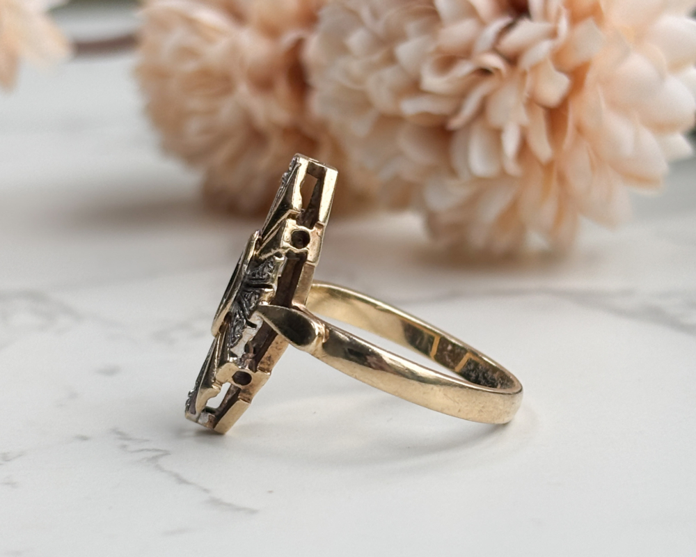 Vintage 9ct gold emerald and diamond ring with a Deco-style lozenge face, stepped gold panels and natural marquise emerald centre. A bold yet wearable design.