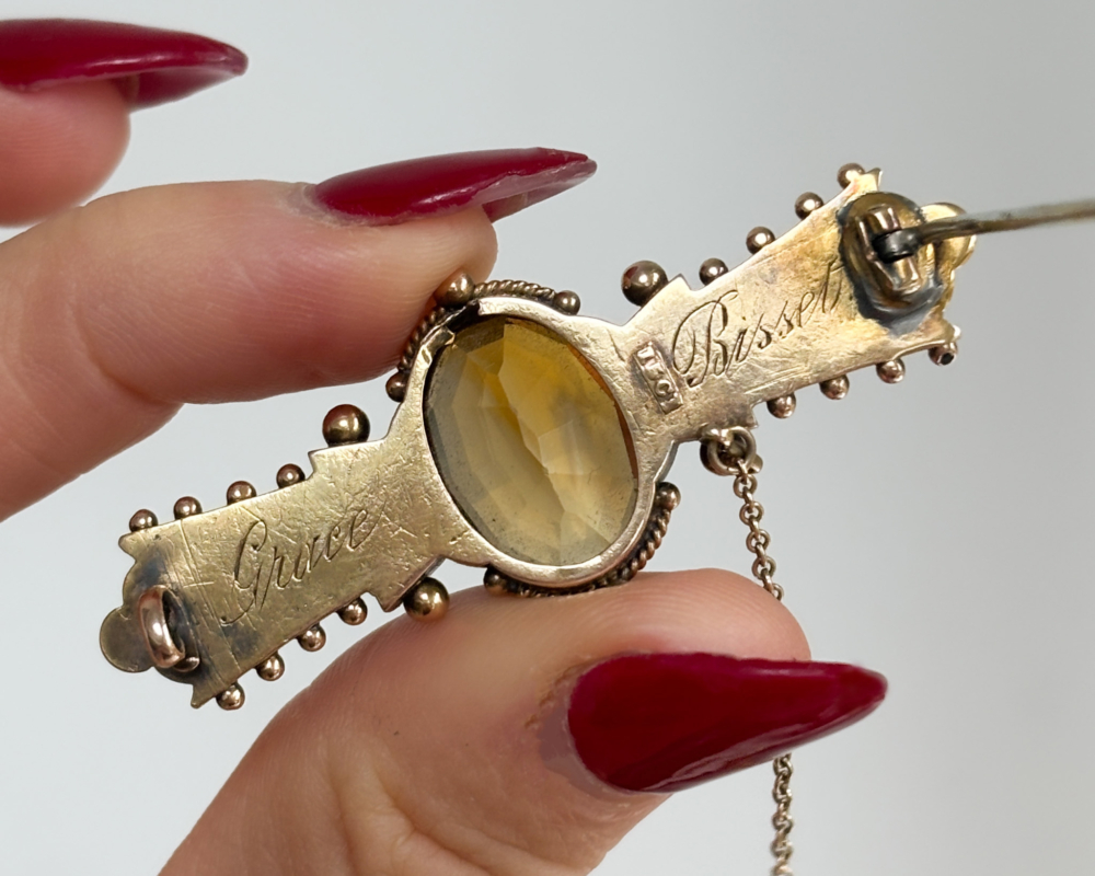 antique Victorian citrine brooch in 15ct gold showing back of the brooch with an inscription
