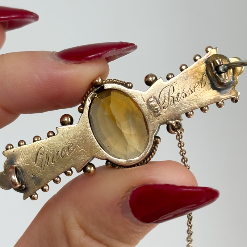 antique Victorian citrine brooch in 15ct gold showing back of the brooch with an inscription