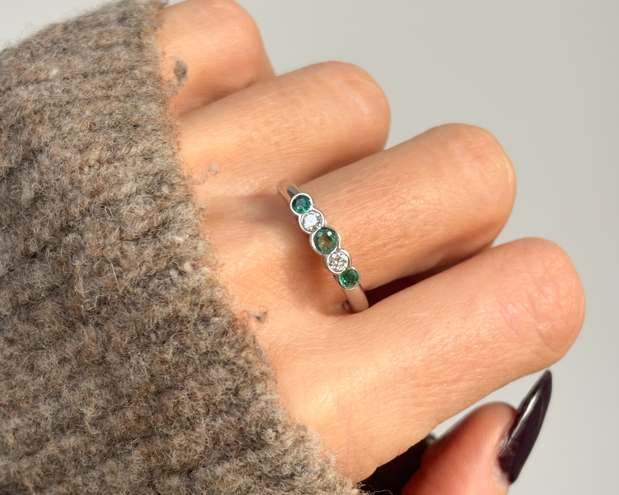 emerald and diamond ring on hand