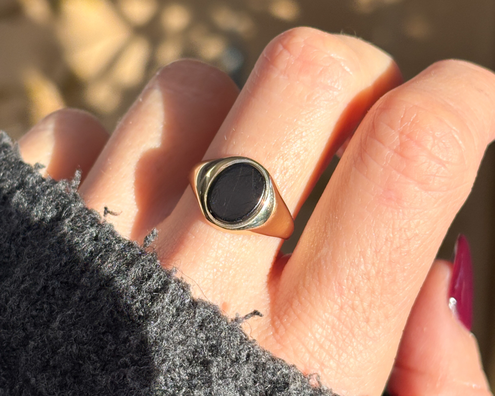 vintage onyx signet ring in 9ct gold dated 1972 for sale in Leeds, shown on woman's hand