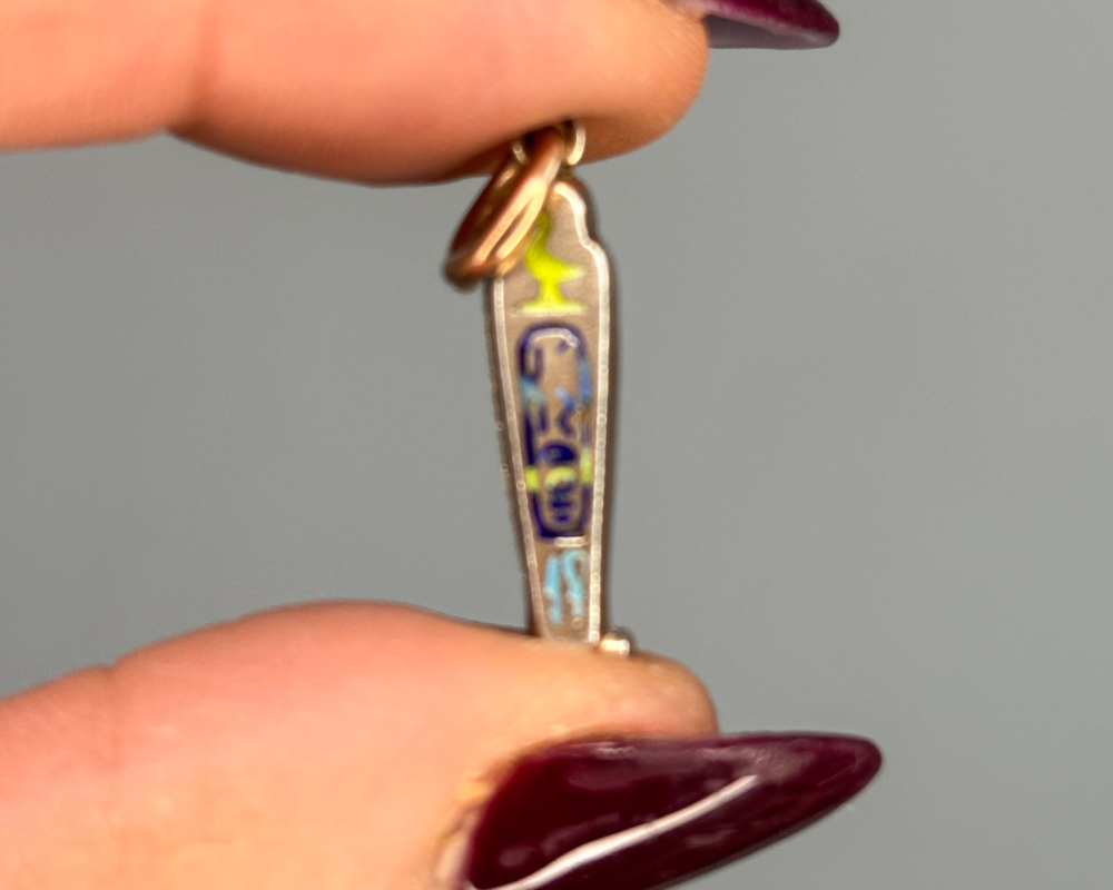 antique Egyptian Revival sarcophagus charm in silver gilt and enamel for sale in Leeds, showing back of charm