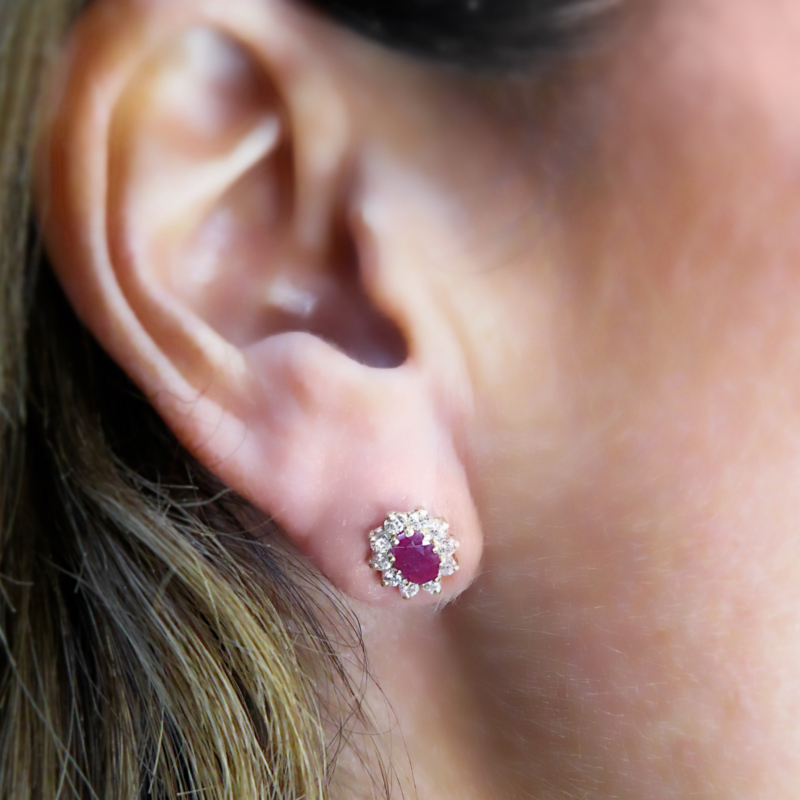 ruby cluster studs set with CZ in 9ct gold, on woman's ear