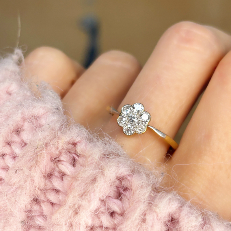 antique 1930s diamond daisy cluster ring for sale in Leeds, shown on a woman's finger
