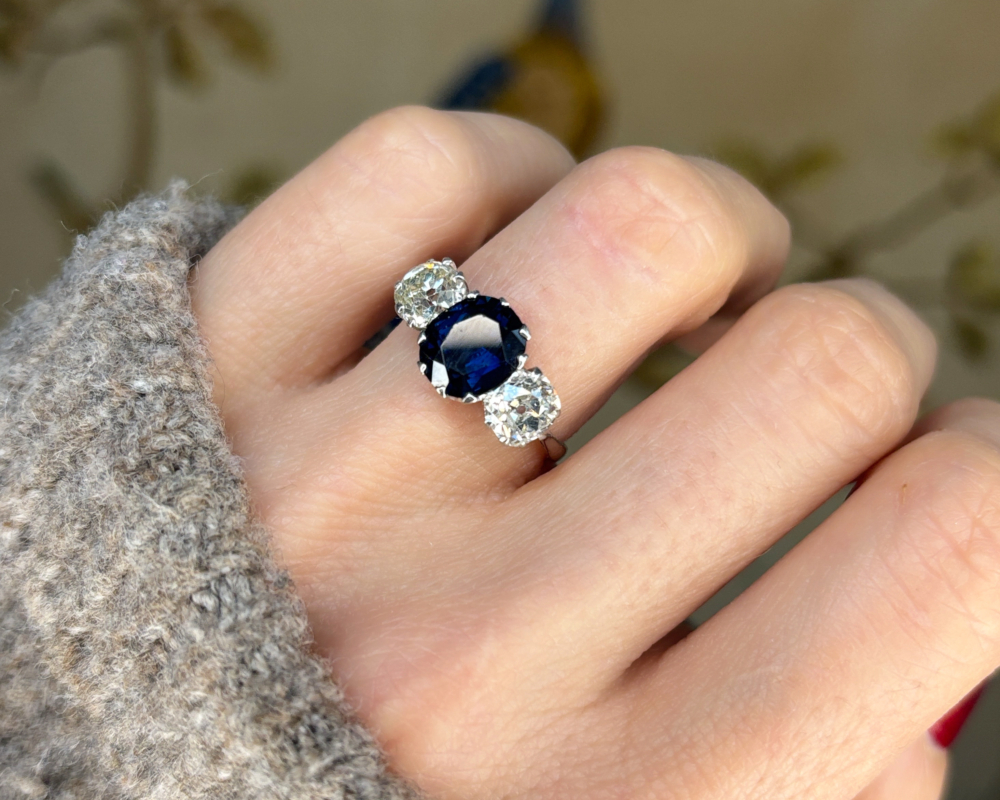 art deco sapphire and diamond three stone in platinum with 2ct sapphire and 1.2ct diamonds for sale in Leeds, shown on hand
