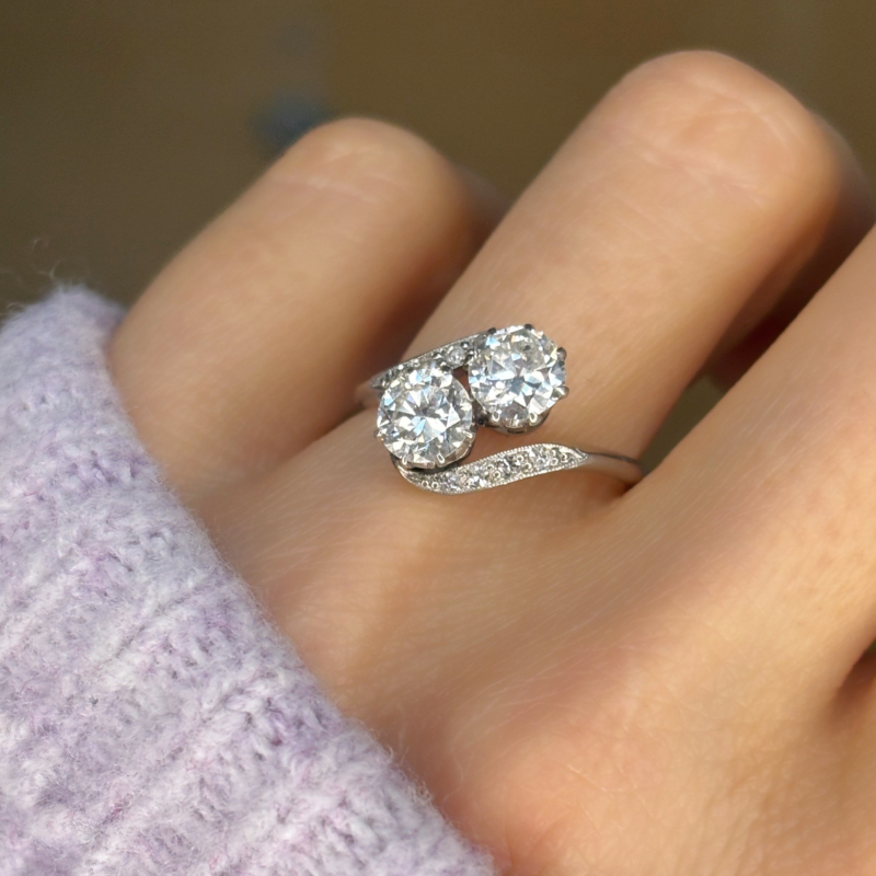 Antique 1920s toi et moi diamond ring 1.5ct transitional diamonds in platinum shown on woman's finger