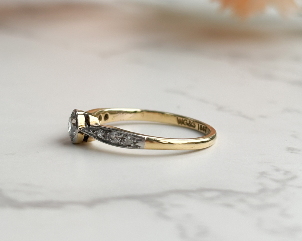 antique Art Deco 1930s diamond solitaire ring approx 0.25ct in 18ct yellow gold and platinum with a bezel setting, showing side of the ring