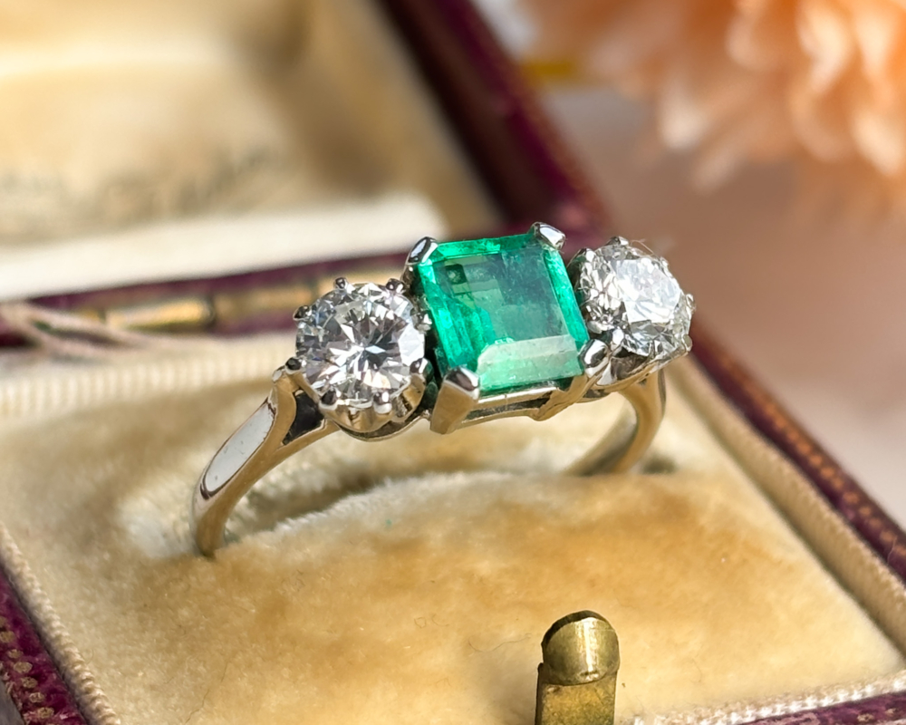 antique Art Deco emerald and diamond three stone ring for sale in Leeds, shown in an antique brown box