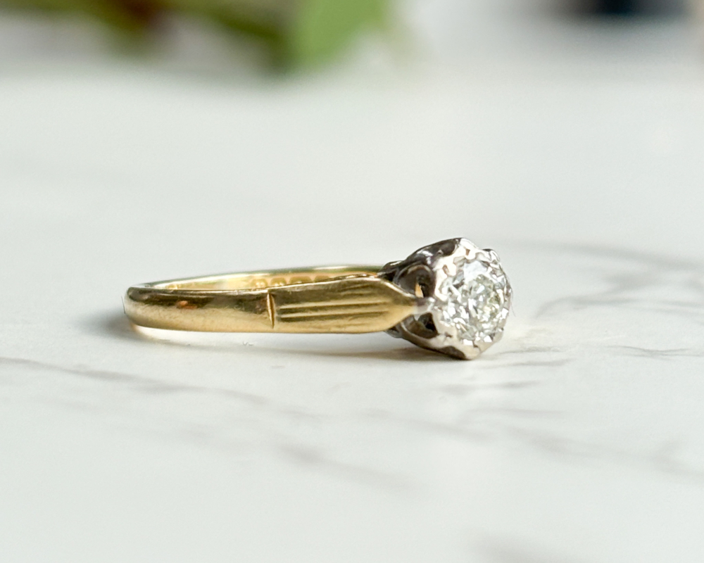 vintage diamond solitaire ring in 18ct gold for sale in Leeds, shown on a woman's hand, showing side of the ring