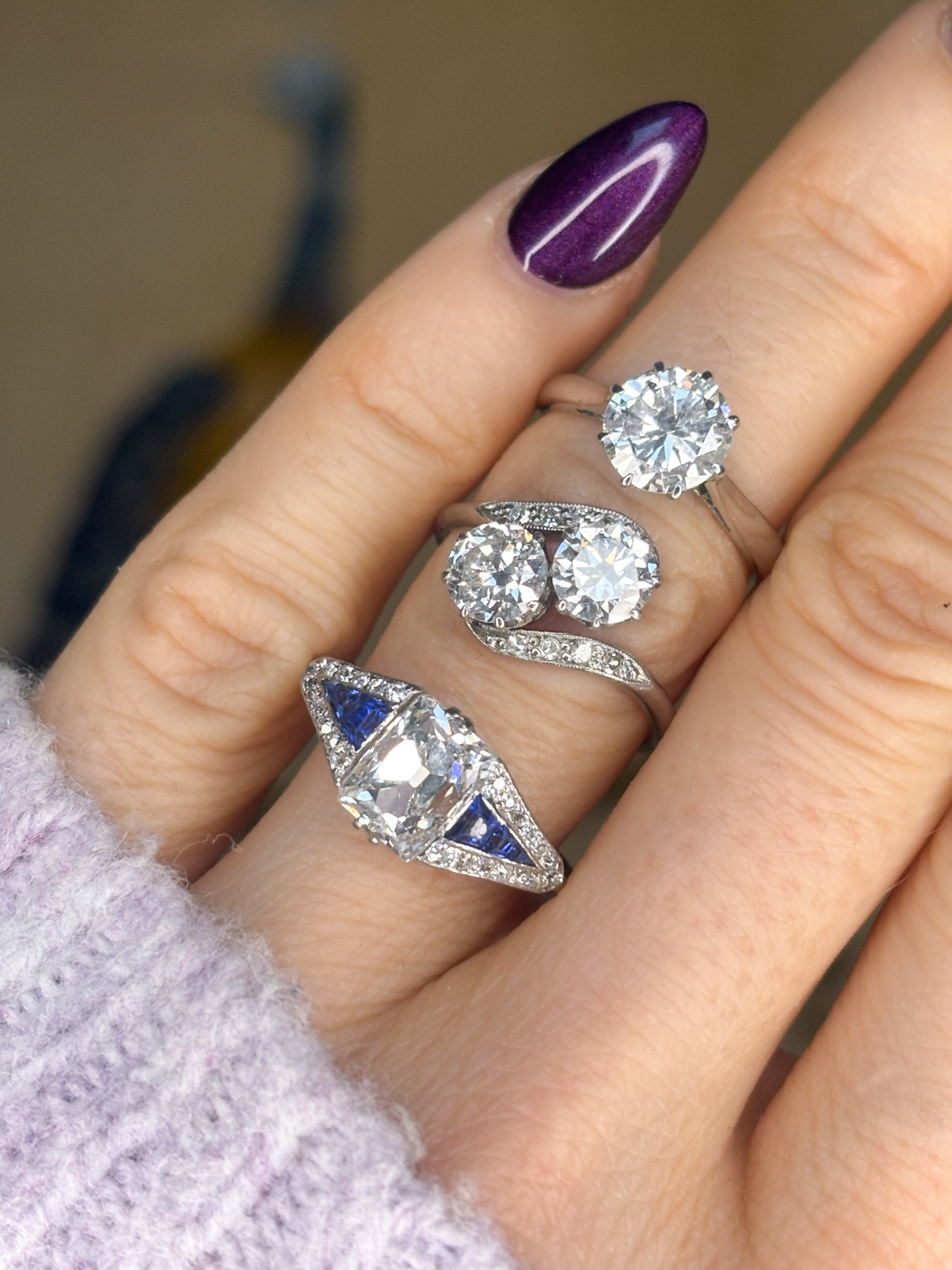 antique engagement rings on a finger