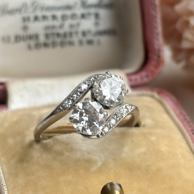 Antique 1920s toi et moi diamond ring 1.5ct transitional diamonds in platinum shown in a pink box