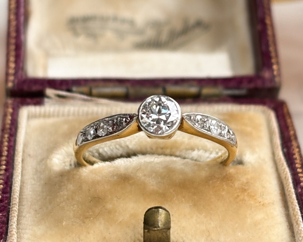 antique Art Deco 1930s diamond solitaire ring approx 0.25ct in 18ct yellow gold and platinum with a bezel setting, shown in an antique brown box