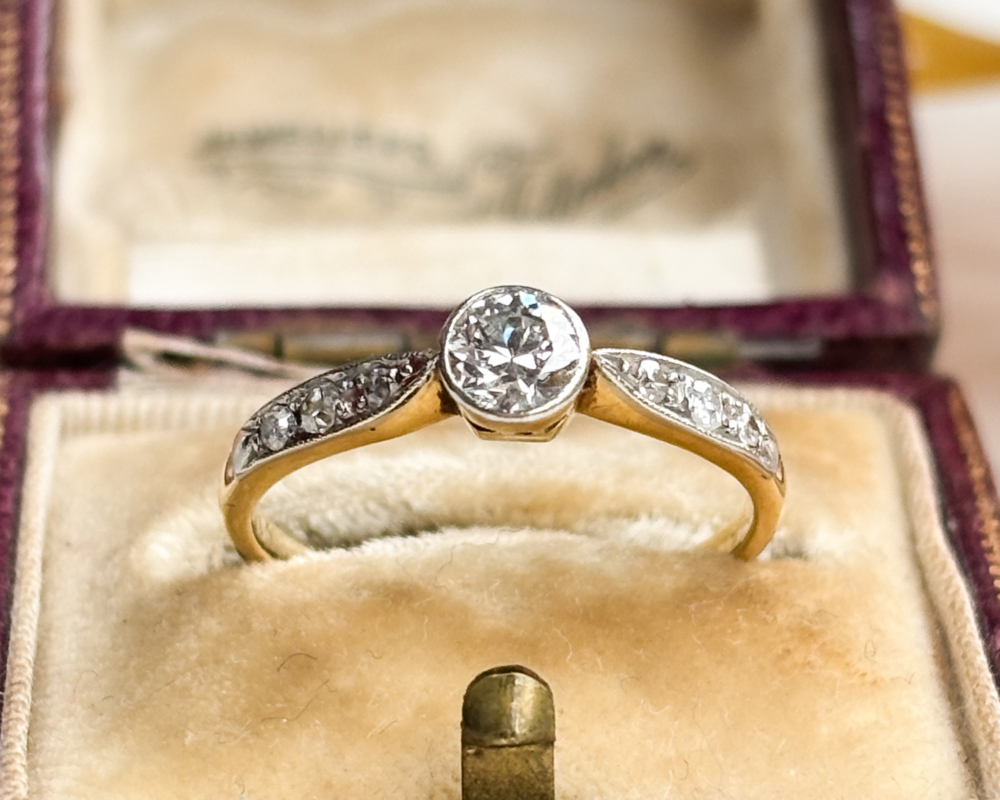 antique Art Deco 1930s diamond solitaire ring approx 0.25ct in 18ct yellow gold and platinum with a bezel setting, shown in an antique brown box