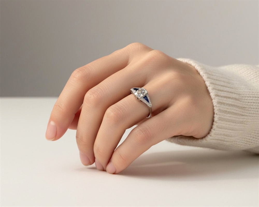 antique Art Deco old mine cut diamond set in platinum with sapphire shoulders. 2.4ct centre stone, for sale in Leeds, UK, shown on model's hand