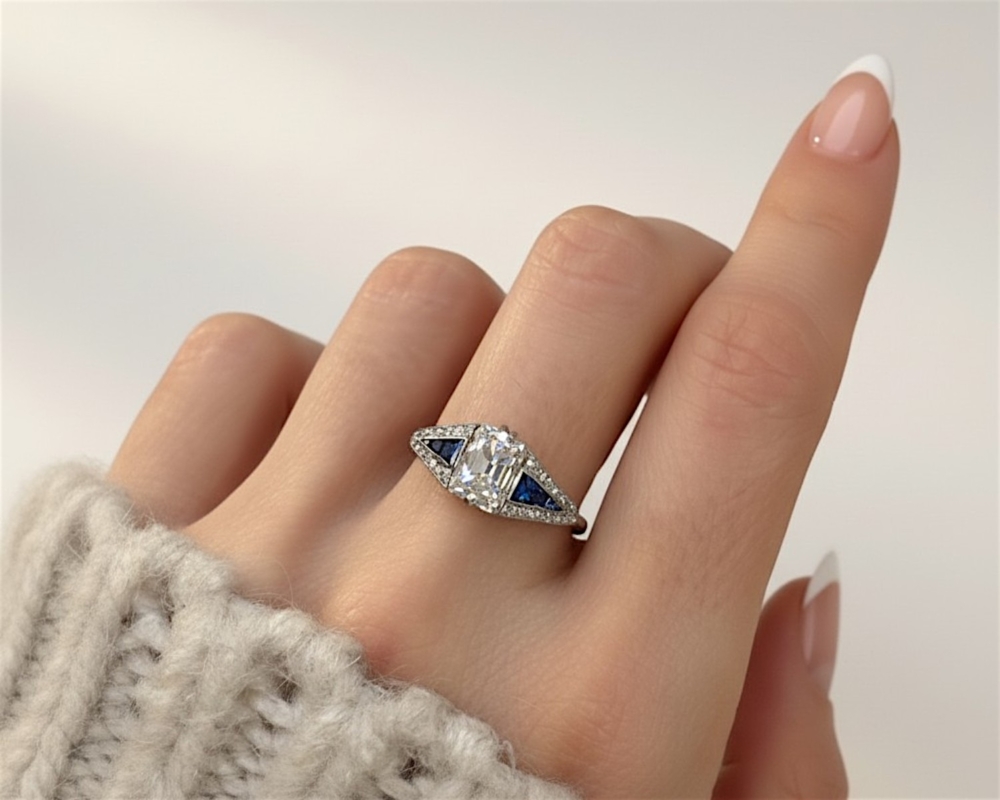 antique Art Deco old mine cut diamond set in platinum with sapphire shoulders. 2.4ct centre stone, for sale in Leeds, UK, on model's hand