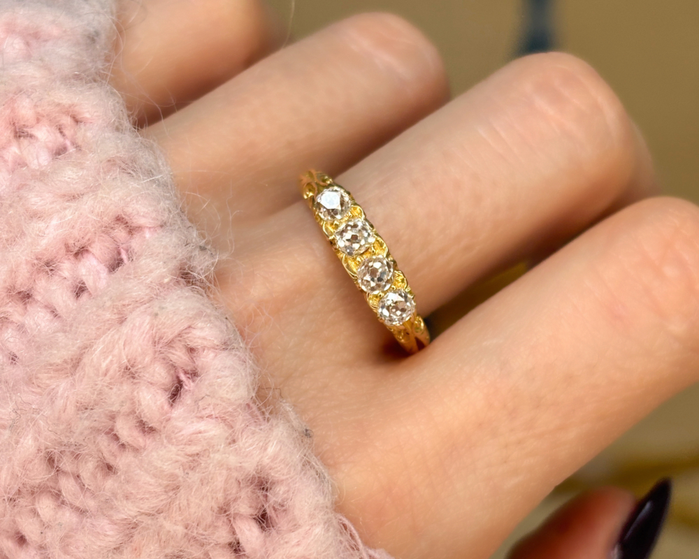 antique Victorian four stone diamond in 18ct yellow gold. Hallmarks for London 1901. Shown on a woman's hand