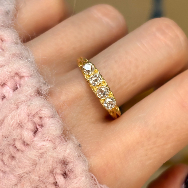 antique Victorian four stone diamond in 18ct yellow gold. Hallmarks for London 1901. Shown on a woman's hand