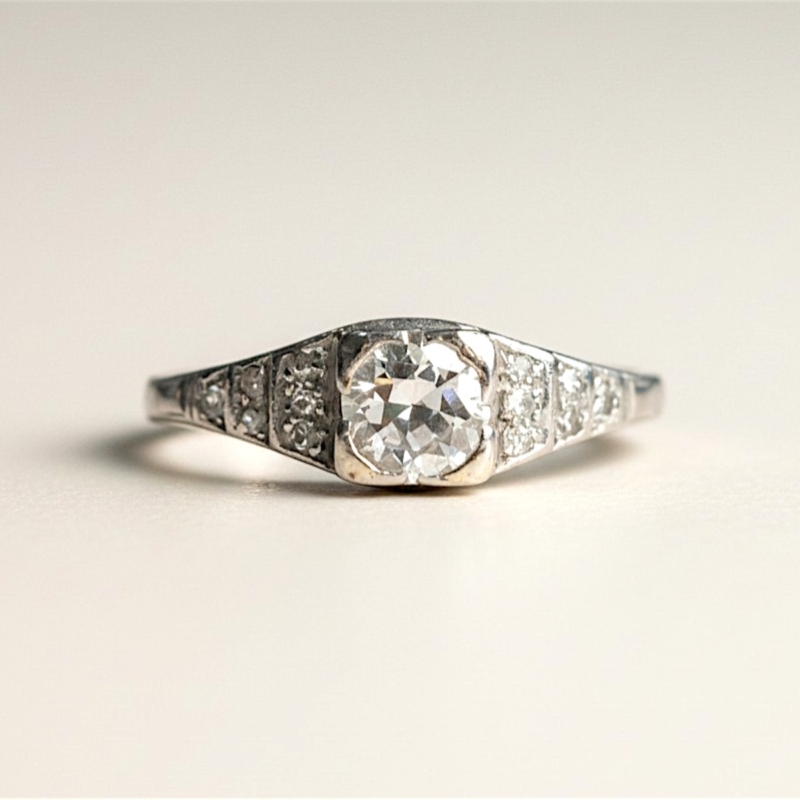 art deco diamond solitaire ring with stepped shoulders in platinum